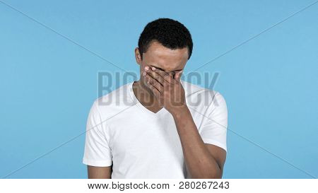 Sad Upset African Man Isolated On Blue Background