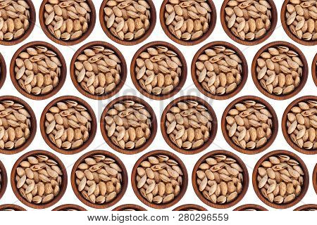 Unpeeled Almonds Badam In A Wooden Cedar Plate On A White Isolated Background. Row Of Bowls With Alm