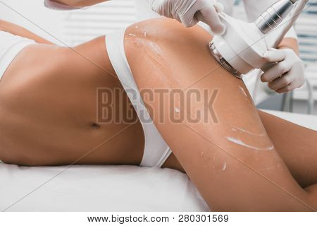 Woman Having Cavitation Procedure, Cellulite Treatment, On Her Buttocks And Legs