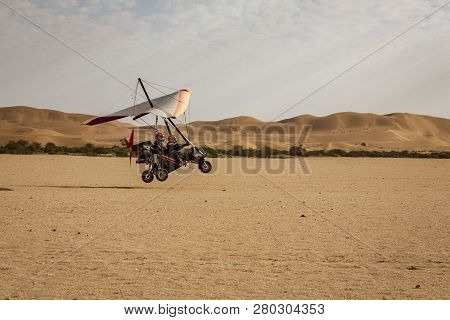 Walvis Bay, Namibia - July 16, 2018: An Ultralight Aircraft Takes Off From An Improved Dirt Runway I