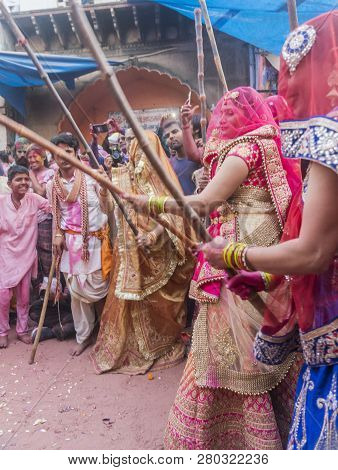 Barsana, India - February 24, 2018 - Lathmar Holi Festival - Women Beat Men With Bamboo Sticks Until