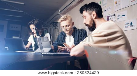 Business Professionals At Working Moments. Group Of Young Confident Coworking People Analyzing Data 