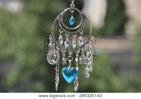 Magical And Miraculous. Luck Amulet Hung Out Outdoor. Silver Amulet With Gems And Pendants. Believin