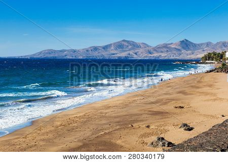 Puerto Del Carmen Beach In Lanzarote, Canary Islands, Spain. Blue Sea, Palm Trees, Selective Focus