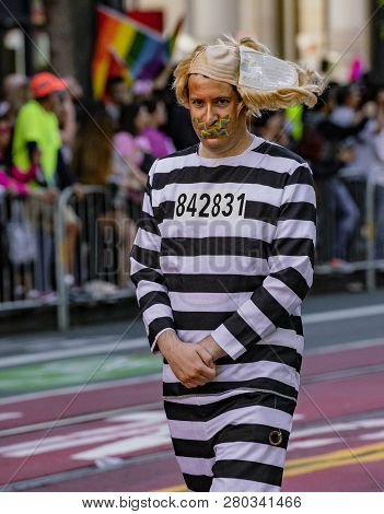 San Francisco, California, June 24, 2018:  Gay Pride Parade - Man Protests Putting Illegal Immigrant