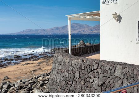 Puerto Del Carmen Beach In Lanzarote, Canary Islands, Spain. Blue Sea, Tourist Information Centre, S