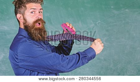 Man Scruffy Use Stapler Dangerous Way. Hipster Teacher Formal Wear Necktie Holds Stapler. School Sta