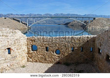 View Out Of The Ruins Of Fortica. The Pag Bridge Connecting The Island Of Pag With The Land.