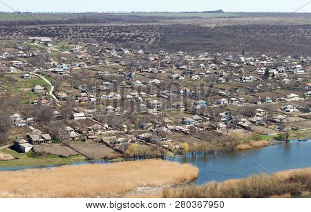River Flowing Between Hills And Villages In Rural Areas. Landscape