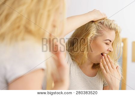 Young Blonde Female Feeling Dull And Tired After Waking Up. Woman Yawning Being Sleepy In Bathroom.