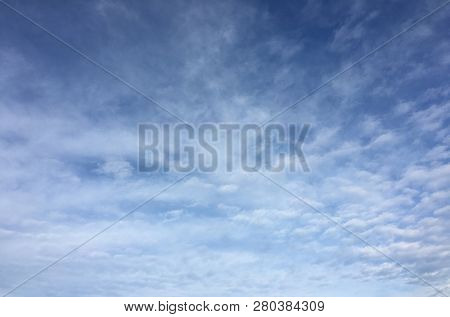 Beautiful Snowy Clouds Against A Blue Sky Background. Sky Cloud. Blue Sky With Winter Clouds Weather