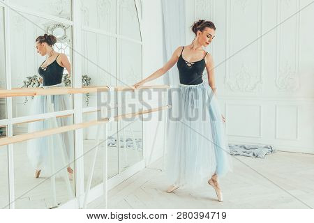 Young Classical Ballet Dancer Woman In Dance Class. Beautiful Graceful Ballerina Practice Ballet Pos