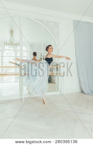 Young Classical Ballet Dancer Woman In Dance Class. Beautiful Graceful Ballerina Practice Ballet Pos