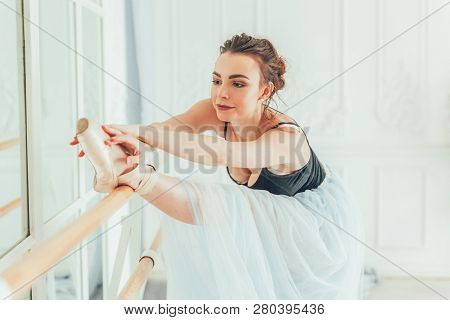 Young Classical Ballet Dancer Woman In Dance Class. Beautiful Graceful Ballerina Practice Ballet Pos