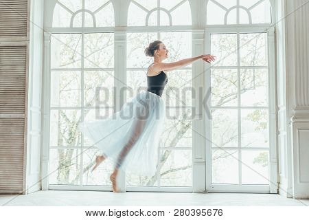 Young Classical Ballet Dancer Woman In Dance Class. Beautiful Graceful Ballerina Practice Ballet Pos