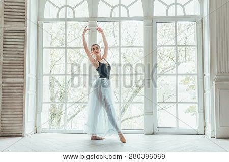 Young Classical Ballet Dancer Woman In Dance Class. Beautiful Graceful Ballerina Practice Ballet Pos