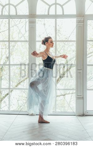 Young Classical Ballet Dancer Woman In Dance Class. Beautiful Graceful Ballerina Practice Ballet Pos