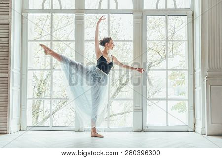 Young Classical Ballet Dancer Woman In Dance Class. Beautiful Graceful Ballerina Practice Ballet Pos