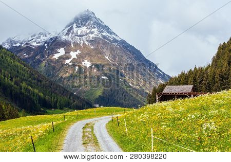 Summer Mountain Landscape With Blossoming Slope And Country Road (silvretta Alps, Austria).