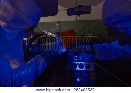 Crime Investigation - Looking For Evidences And Traces In Suspected Car In Police Garage Under Uv Li