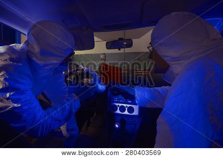 Crime Investigation - Looking For Evidences And Traces In Suspected Car In Police Garage Under Uv Li