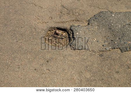 Close-up Of Damaged Asphalt Road With Pothole