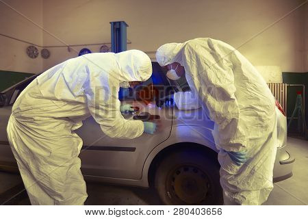 Crime Investigation - Developing Of Fingerprints On Suspected Car In Police Garage Under Uv Light