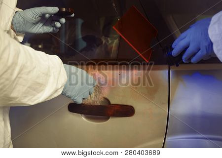 Crime Investigation - Developing Of Fingerprints On Suspected Car In Police Garage Under Uv Light