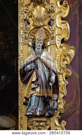 LUCERNE, SWITZERLAND - JUNE 24, 2018: Saint Martin statue on the altar of Saint Leodegar in the church of St. Leodegar in Lucerne, Switzerland