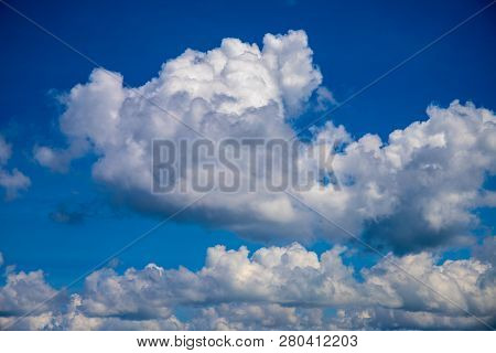 White Cloud On Blue Sky. Sunny Cloudscape Photo Background. Optimistic Skyscape With Fluffy Cloud. F