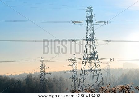 A Transmission Tower Or Electricity Pylon With Blue Sky. It Is A Tall Structure, Usually A Steel Lat