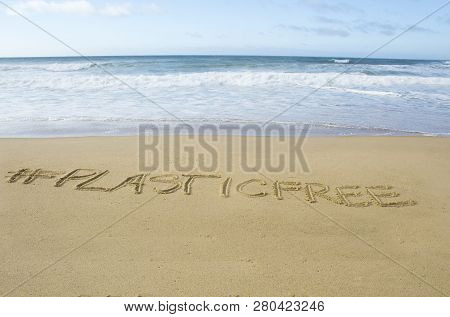 Inscription #plasticfree Written On The Sand On The Shores Of The Atlantic Ocean