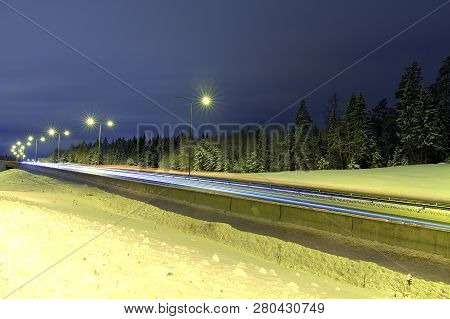 Light Trails Of The Cars On Snowy Highway