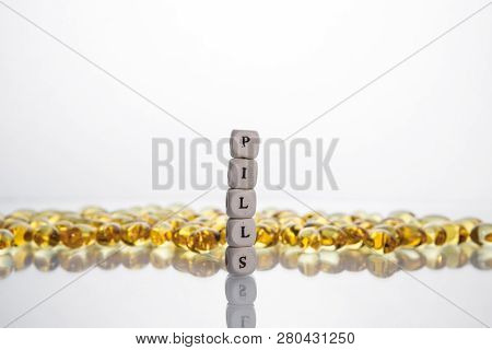 Word Pills From The Letters Of Cubes And Lecithin Gel Pills On Light Background. Soy And Sunflower L