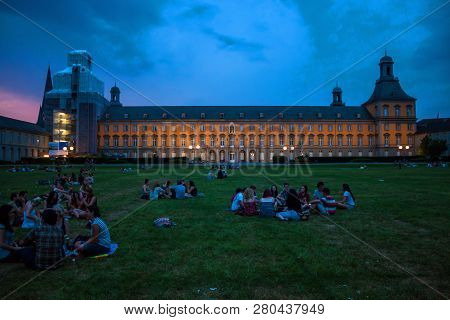 Bonn, Germany - July 22: Students Of University In Bonn Sit In Front Of Main Building Of University 