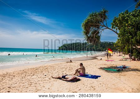Mirissa Beach, Sri Lanka - JAN 2, 2017:  Tourists walking on the sand while enjoying the view across the wonderful beach of Mirissa on Jan 2, 2017. Sri Lanka.