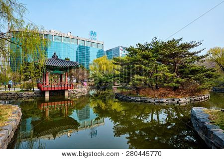 SEOUL, SOUTH KOREA - APRIL 8, 2017: Yeouido Park public park pond with pavilion summerhouse in Seoul, Korea