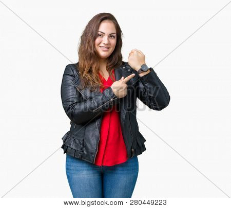 Beautiful plus size young woman wearing a fashion leather jacket over isolated background In hurry pointing to watch time, impatience, upset and angry for deadline delay