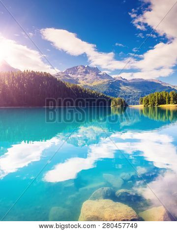 Fantastic view of the azure pond Champfer. Picturesque scene. Location: resort Silvaplana village, district of Maloja in the Swiss canton of Graubunden, Alps. Europe. Artistic picture. Beauty world.