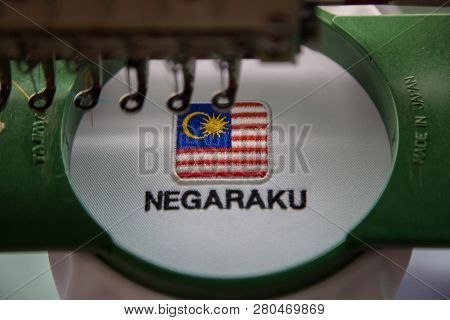 Close-up Of Embroidery Malaysia Logo With Wording Negaraku (my Country) On White Uniform