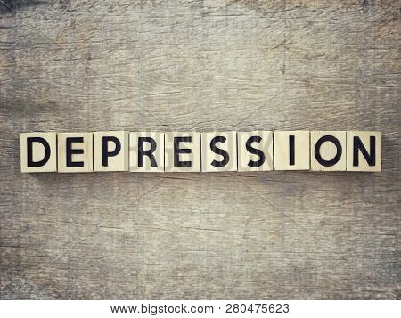 Motivational And Inspirational Word - Depression Written On Wooden Blocks And Arranged On A Wooden T