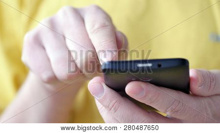 Close-up Of Hands Holding Smartphone, Typing Text On Touch Screen And Using Applications. A Person T