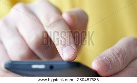 Close-up Of Hands Holding Smartphone, Typing Text On Touch Screen And Using Applications. A Person T