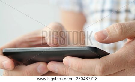 Close-up Of Hands Holding Smartphone, Typing Text On Touch Screen And Using Applications. A Person T