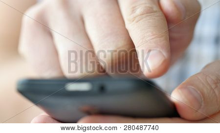 Close-up Of Hands Holding Smartphone, Typing Text On Touch Screen And Using Applications. A Person T