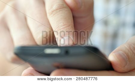 Close-up Of Hands Holding Smartphone, Typing Text On Touch Screen And Using Applications. A Person T