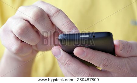 Close-up Of Hands Holding Smartphone, Typing Text On Touch Screen And Using Applications. A Person T