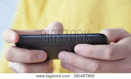 Close-up Of Hands Holding Smartphone, Typing Text On Touch Screen And Using Applications. A Person T