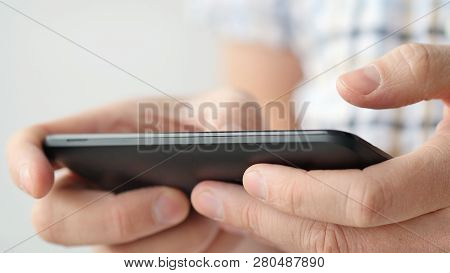 Close-up Of Hands Holding Smartphone, Typing Text On Touch Screen And Using Applications. A Person T