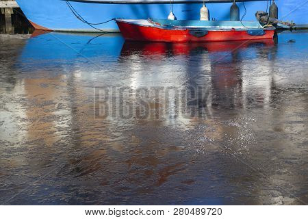 Old Picturesque Red Boat In Frozen Water In Brielle In The Netherlands